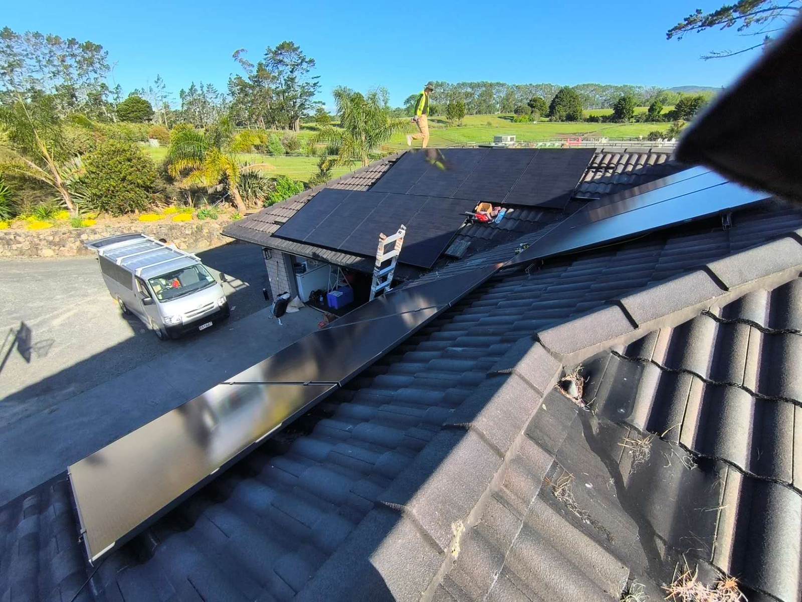 Panels being mounted on the concrete tile roof